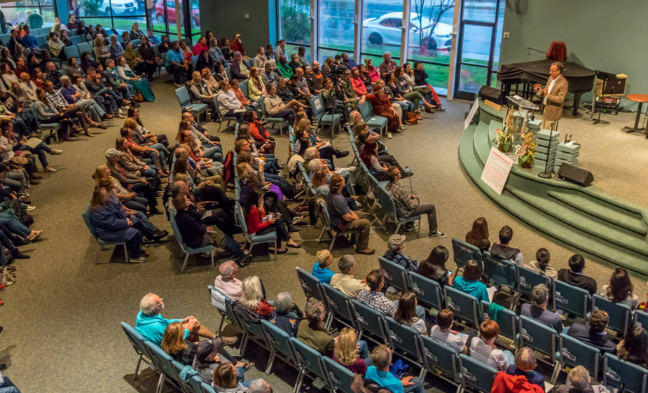 Nelson Campbell addressing a packed audience at a workshop event